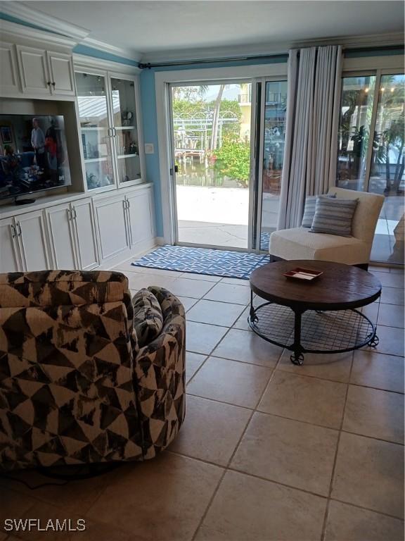 tiled living room featuring crown molding