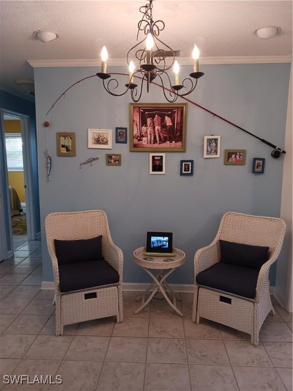 sitting room featuring tile patterned floors, crown molding, and a chandelier