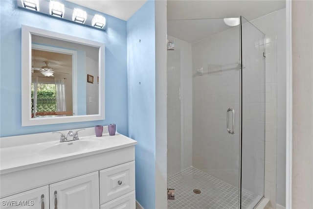 bathroom featuring vanity, ceiling fan, and a shower with shower door