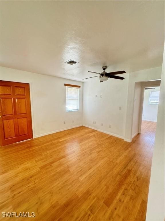 empty room featuring ceiling fan and light wood-type flooring