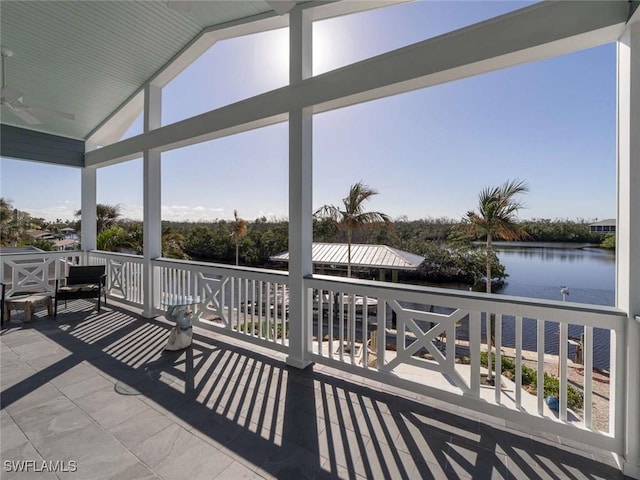 exterior space with ceiling fan and a water view