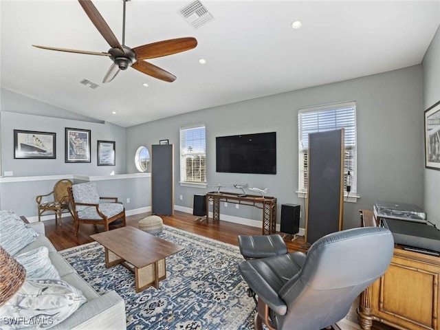 living room featuring ceiling fan, dark hardwood / wood-style flooring, and vaulted ceiling