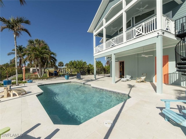 view of pool with ceiling fan and a patio