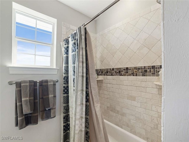 bathroom with shower / tub combo with curtain