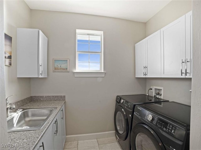 laundry area with cabinets, independent washer and dryer, sink, and light tile patterned floors