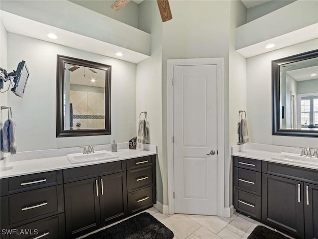 bathroom featuring ceiling fan, a towering ceiling, and vanity