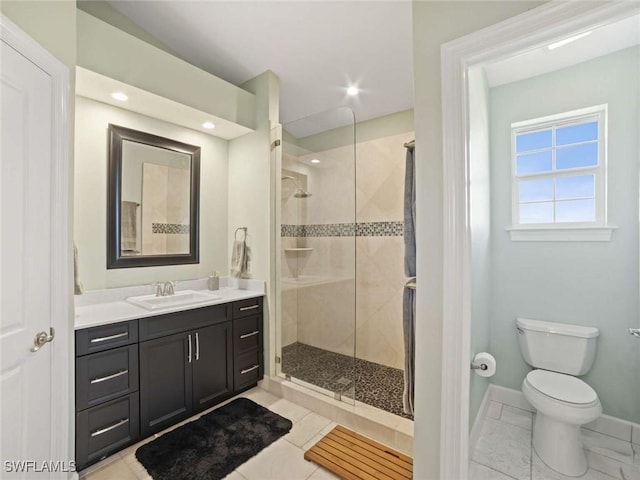 bathroom featuring vanity, toilet, and walk in shower