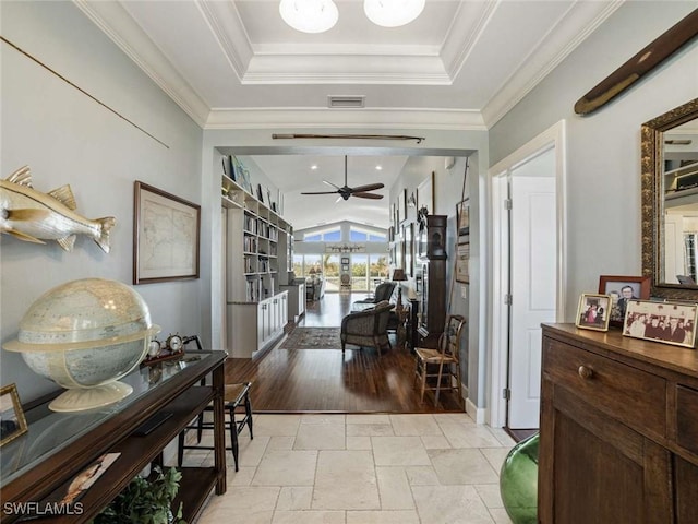 hall featuring ornamental molding and lofted ceiling