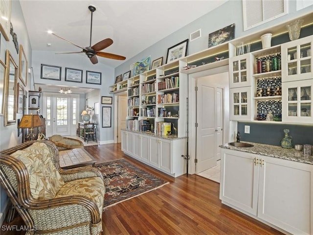 living room featuring dark hardwood / wood-style floors, ceiling fan, sink, and french doors