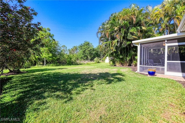 view of yard with a sunroom