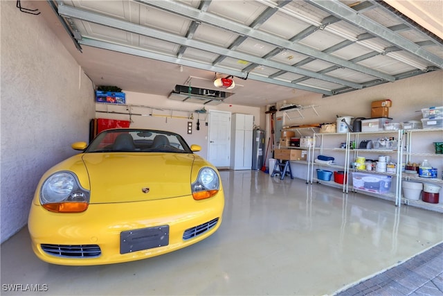 garage featuring electric water heater and a garage door opener