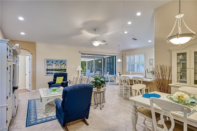 living room with ceiling fan, light tile patterned flooring, and crown molding