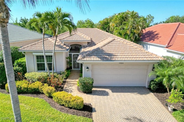 mediterranean / spanish-style home with a garage