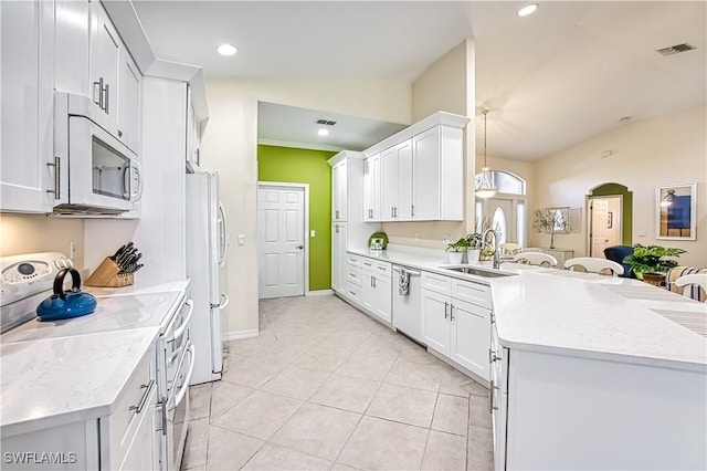 kitchen featuring sink, hanging light fixtures, vaulted ceiling, white appliances, and white cabinets