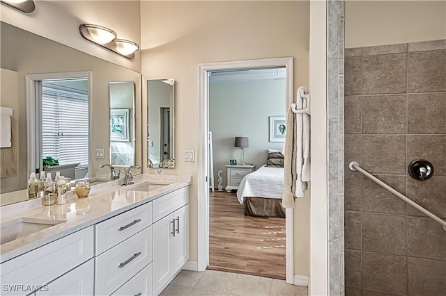 bathroom featuring tile patterned flooring, vanity, and walk in shower