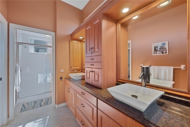 bathroom featuring vanity, tile patterned floors, and a shower with door