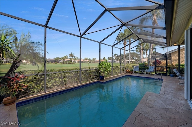 view of pool featuring glass enclosure and a patio area