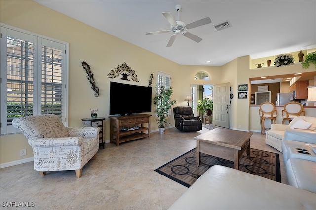 living room with ceiling fan and light tile patterned floors