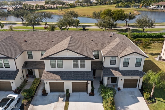 view of front facade featuring a water view and a garage