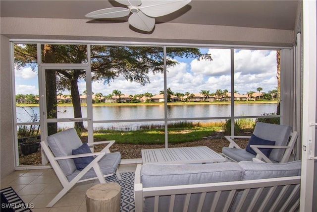 sunroom / solarium featuring a wealth of natural light, a water view, and ceiling fan