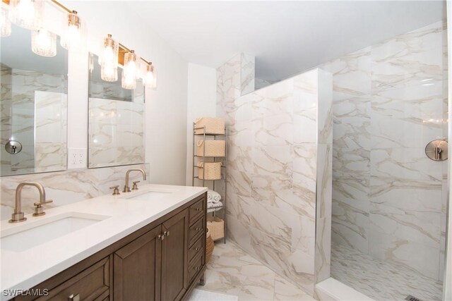 bathroom featuring vanity, tile walls, and tiled shower