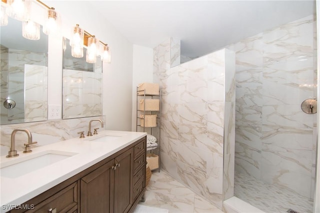 full bath featuring marble finish floor, double vanity, a sink, and a marble finish shower