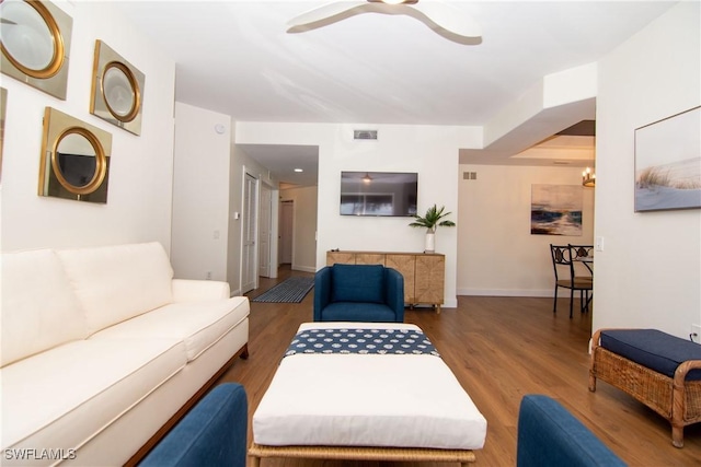 living room featuring dark hardwood / wood-style floors and ceiling fan