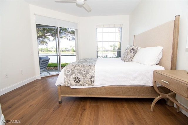 bedroom with access to exterior, ceiling fan, dark hardwood / wood-style floors, and multiple windows