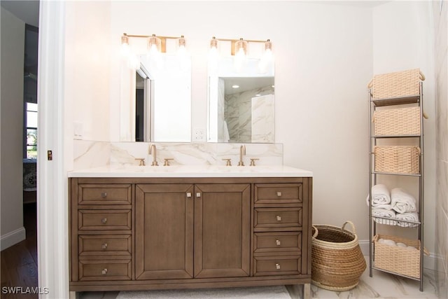 bathroom with hardwood / wood-style flooring, vanity, and tasteful backsplash