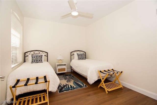 bedroom with ceiling fan and dark hardwood / wood-style flooring