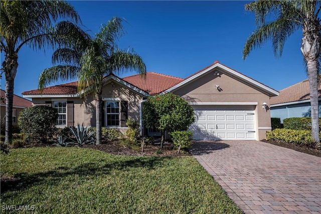 ranch-style home with a front yard and a garage