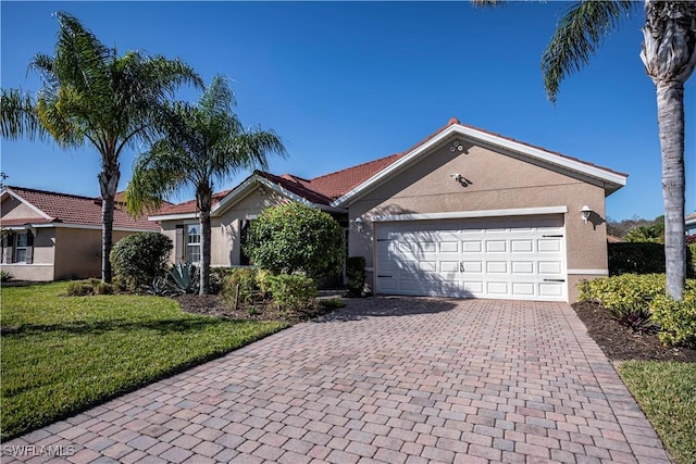 single story home featuring a garage and a front lawn