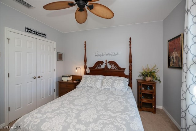 carpeted bedroom with ceiling fan and a closet