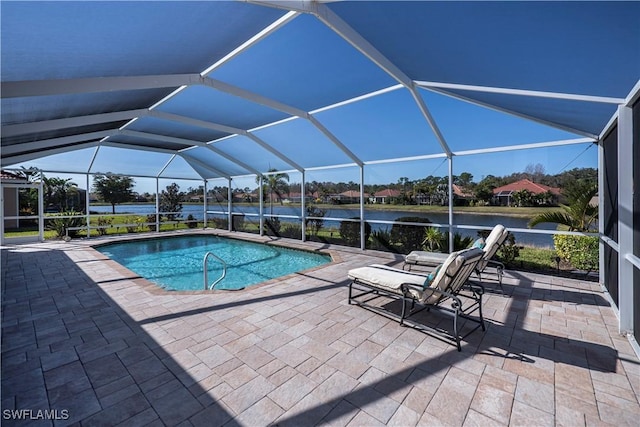 view of swimming pool with a lanai, a patio area, and a water view