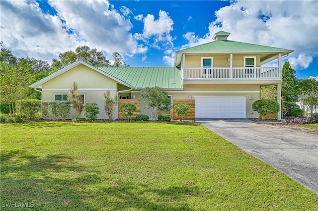 view of front of property with a front yard and a garage