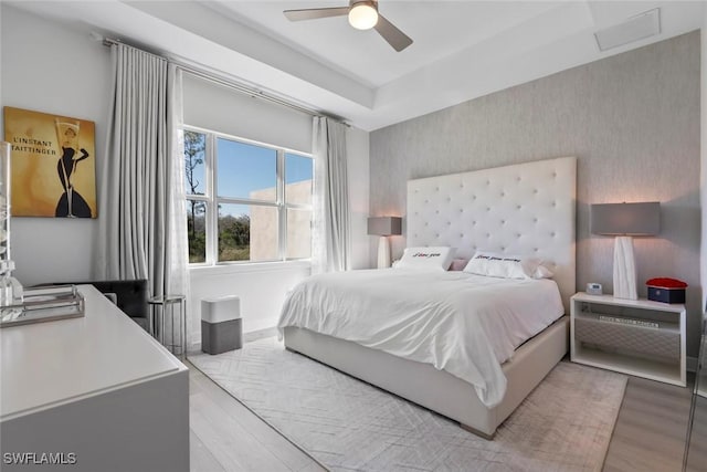 bedroom with light hardwood / wood-style flooring and ceiling fan