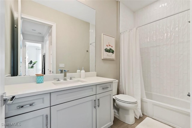 full bathroom with shower / bathtub combination with curtain, hardwood / wood-style floors, vanity, and toilet