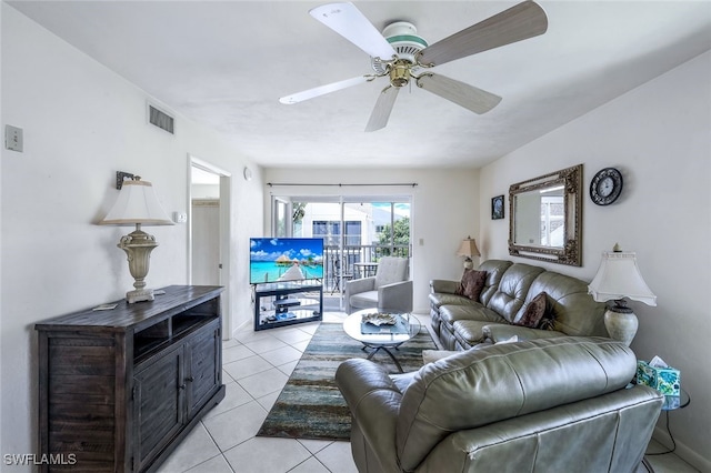 tiled living room with ceiling fan