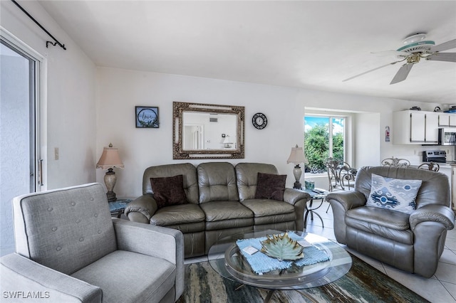 living room featuring ceiling fan and tile patterned flooring