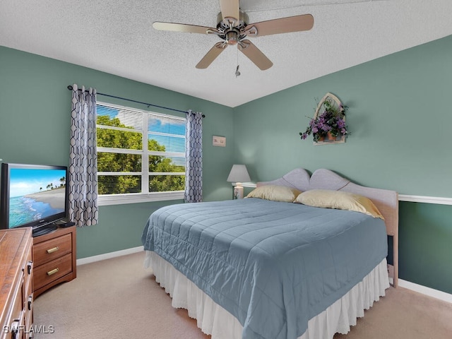 carpeted bedroom with a textured ceiling and ceiling fan