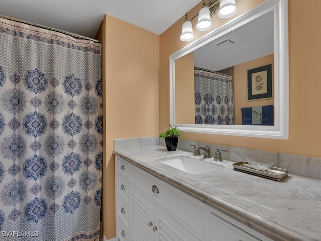 bathroom featuring vanity and a shower with shower curtain