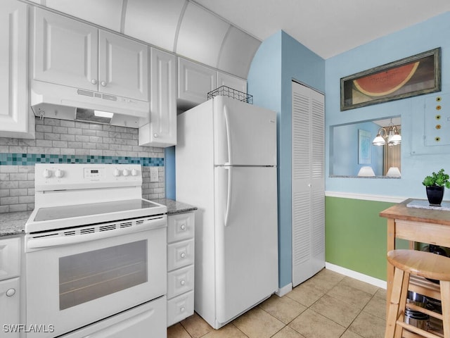 kitchen with backsplash, light stone counters, white appliances, light tile patterned floors, and white cabinetry