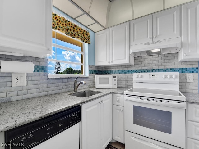 kitchen featuring tasteful backsplash, white cabinetry, sink, and white appliances