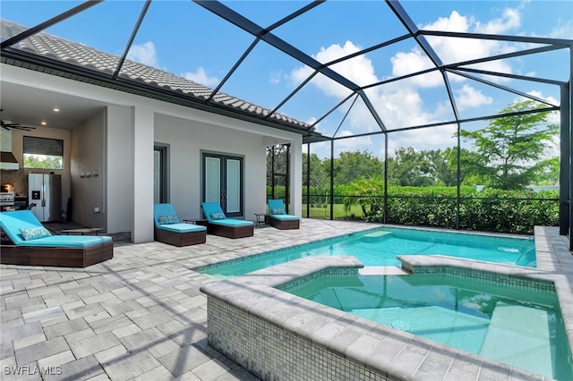 view of pool with a lanai, a patio area, ceiling fan, and french doors