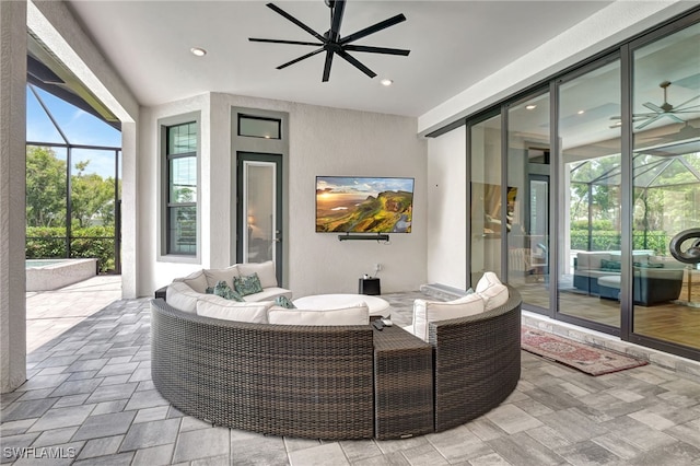 view of patio with outdoor lounge area, glass enclosure, and ceiling fan