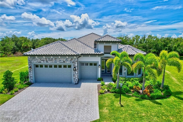 19749 Panther Island Blvd, Estero, FL 33928 - view of front of home with a garage, a front yard, decorative driveway, and stone siding
