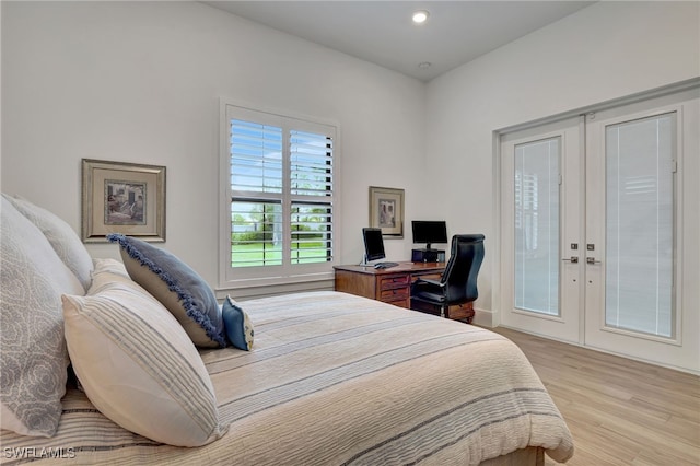 bedroom featuring french doors and light hardwood / wood-style floors