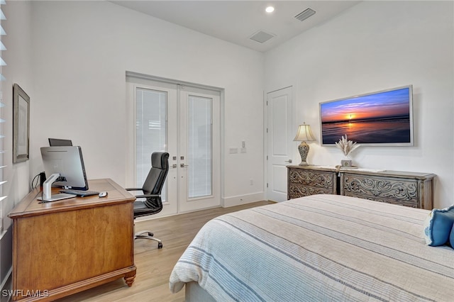 bedroom featuring french doors and light hardwood / wood-style floors