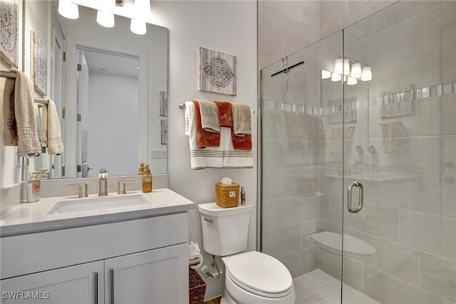 bathroom featuring vanity, toilet, and walk in shower