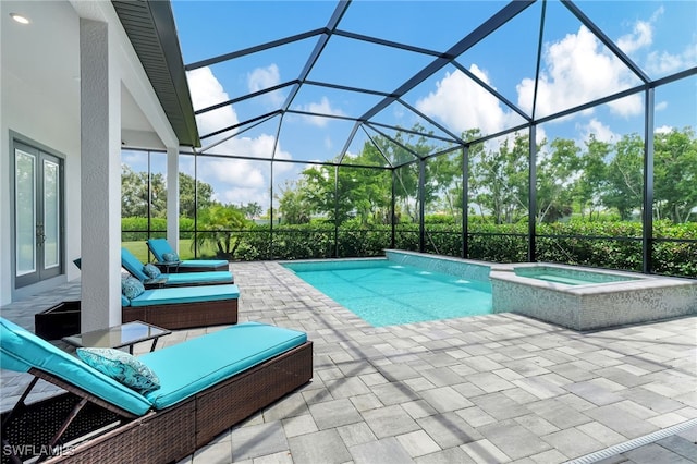 view of pool with an in ground hot tub, glass enclosure, and a patio area